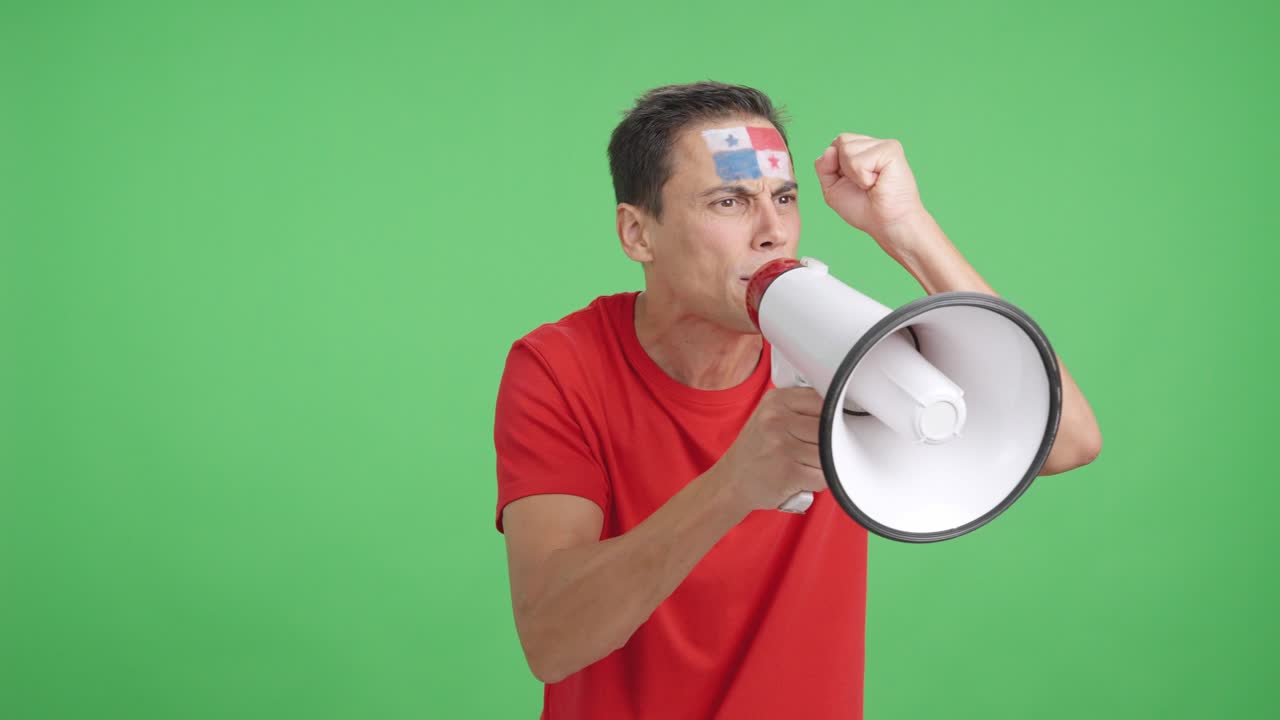 Excited man with panamanian flag on face using a megaphone