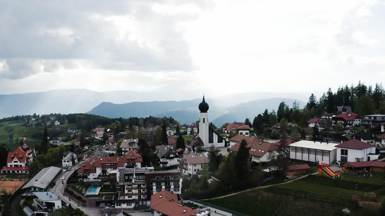 Establishing aerial view of Italy's quaint countryside town of Oberbozen