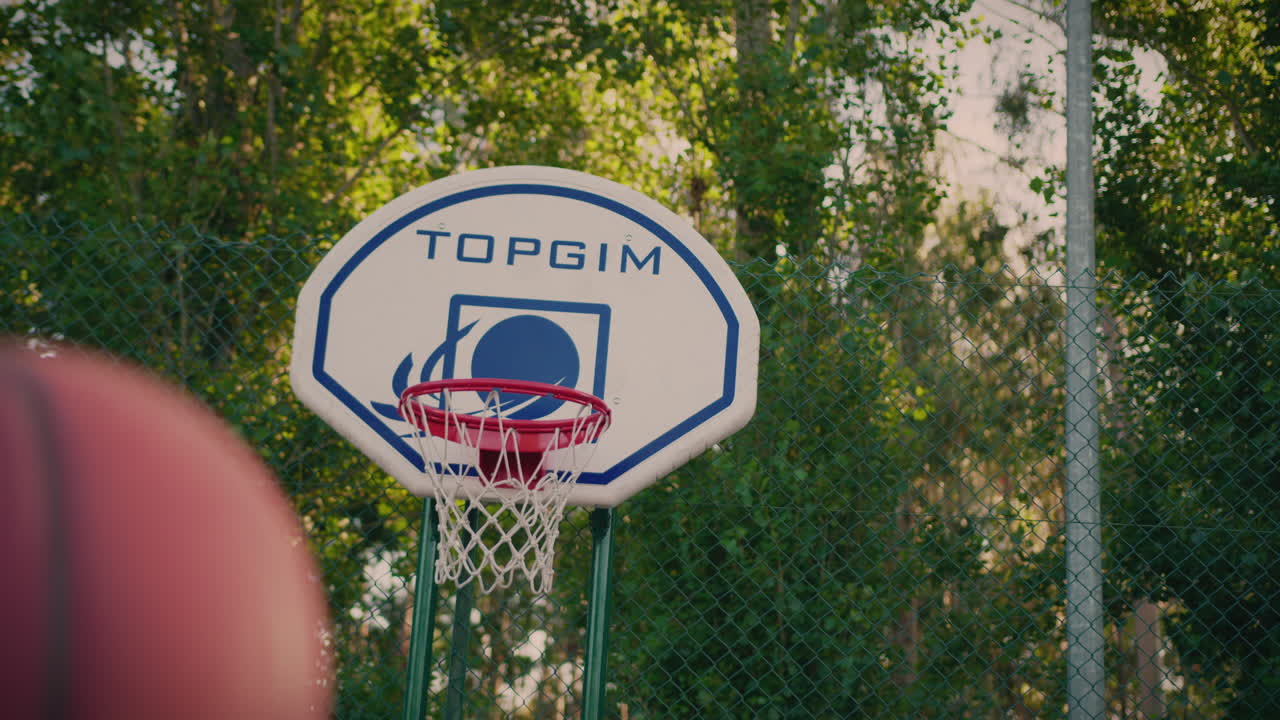 basketball court redhead girl shoots ball and scores dynamic camera movement
