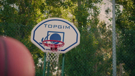 basketball court redhead girl shoots ball and scores dynamic camera movement