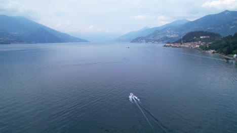 speed boat on beautiful lake como near bellagio, drone flyover