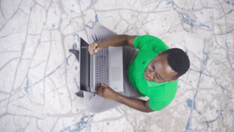 young african american man using laptop rejoice, achieve, happy.