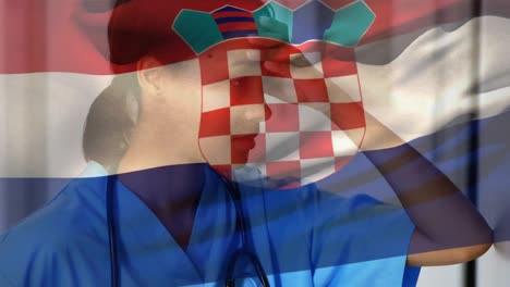 croatia flag waving against stressed african american female health worker at hospital