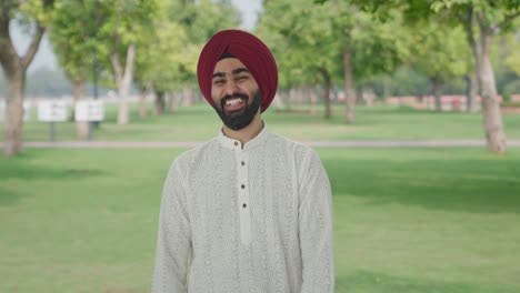 sikh indian man laughing on someone in park