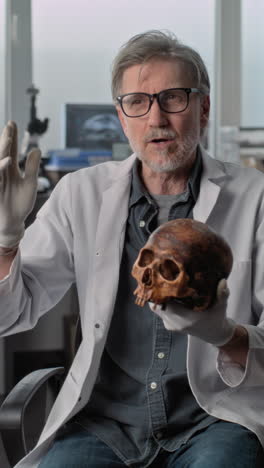 expert discussing a human skull in a lab setting