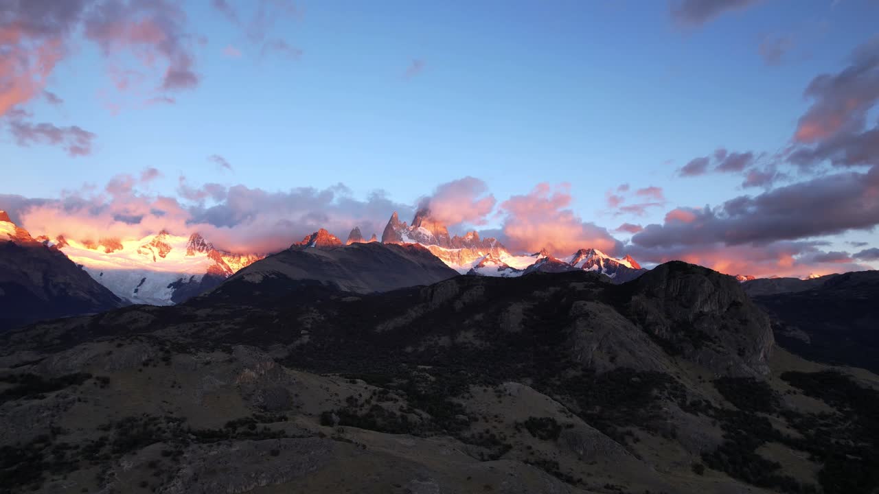 Aerial Drone Footage Captures Breathtaking Views Of Fitz Roy In Argentina At Sunrise. The Mountain, Partially In Shadow, Reveals Its Sunlit Peak, Showcasing A Stunning Cold Morning Atmosphere in 4K