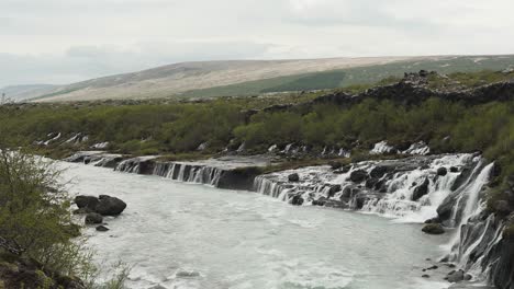 Panning-and-tilting-shot-of-the-amazing-waterfall-Barnafoss-located-in-Iceland,-Europe