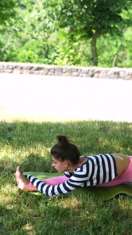 young woman practicing yoga outdoors