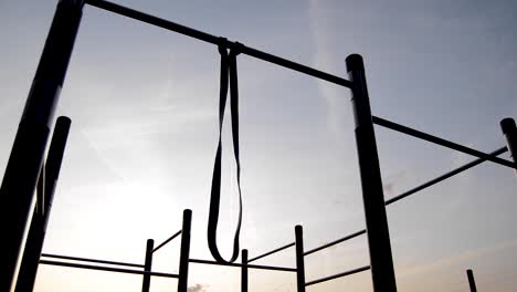 resistance band hanging on bar at sunrise