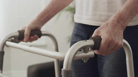 an elderly woman using a frame frame to stand