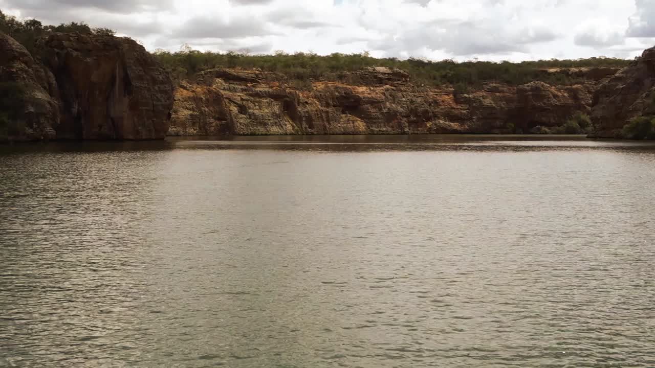 view from a boat sailing among canyons on the waters of San Francisco river, in Sergipe, Brazil