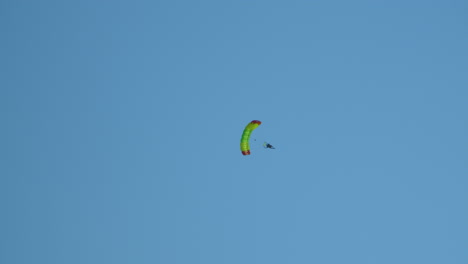 Fallschirmspringer-Fliegt-Mit-Einem-Fallschirm-In-Einem-Blauen,-Klaren-Himmel