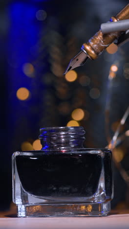 robot da vinci holding a writing pen and dips it into bottle with ink. dark blurred backdrop with some lights. vertical video