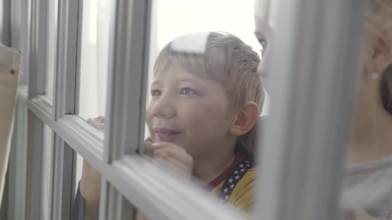 Children Looking Out a Window