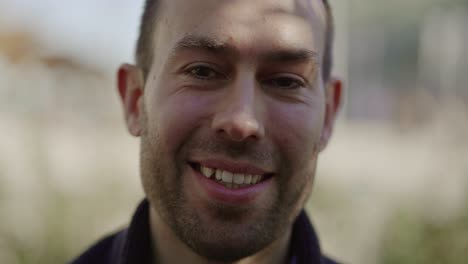 Close-up-shot-of-smiling-handsome-young-man-looking-at-camera