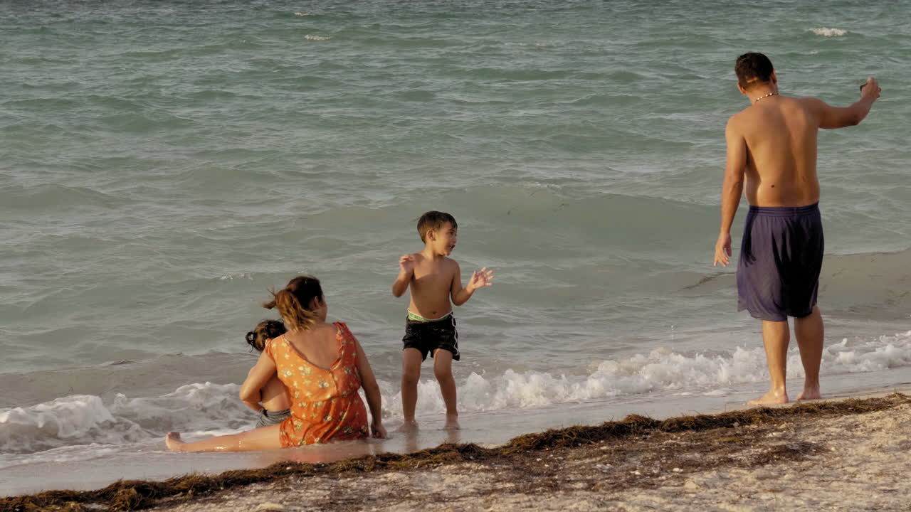 Happy Family With A Child At The Beach  PUERTO PROGRESO LIFE IN MERIDA YUCATAN MEXICO. PROGRESO YUCATAN JANUARY 7, 2019