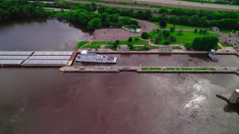 aerial view of a barge being loaded at a dock on the mississippi river near la crescent, minnesota