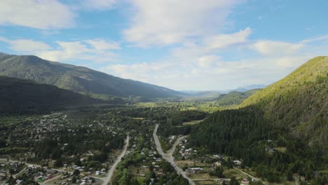 Dolly-in-flying-above-Lago-Puelo-valley-in-the-middle-of-a-beautiful-pine-tree-forest-between-Andean-mountains-at-golden-hour,-Chubut,-Patagonia-Argentina