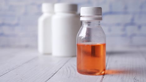 orange liquid medicine in small bottle