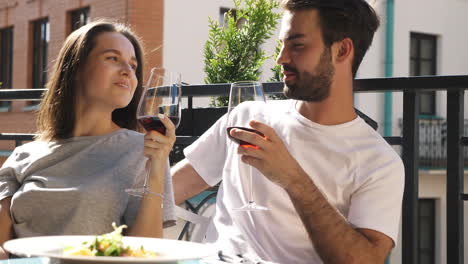 couple enjoying a romantic dinner on a balcony