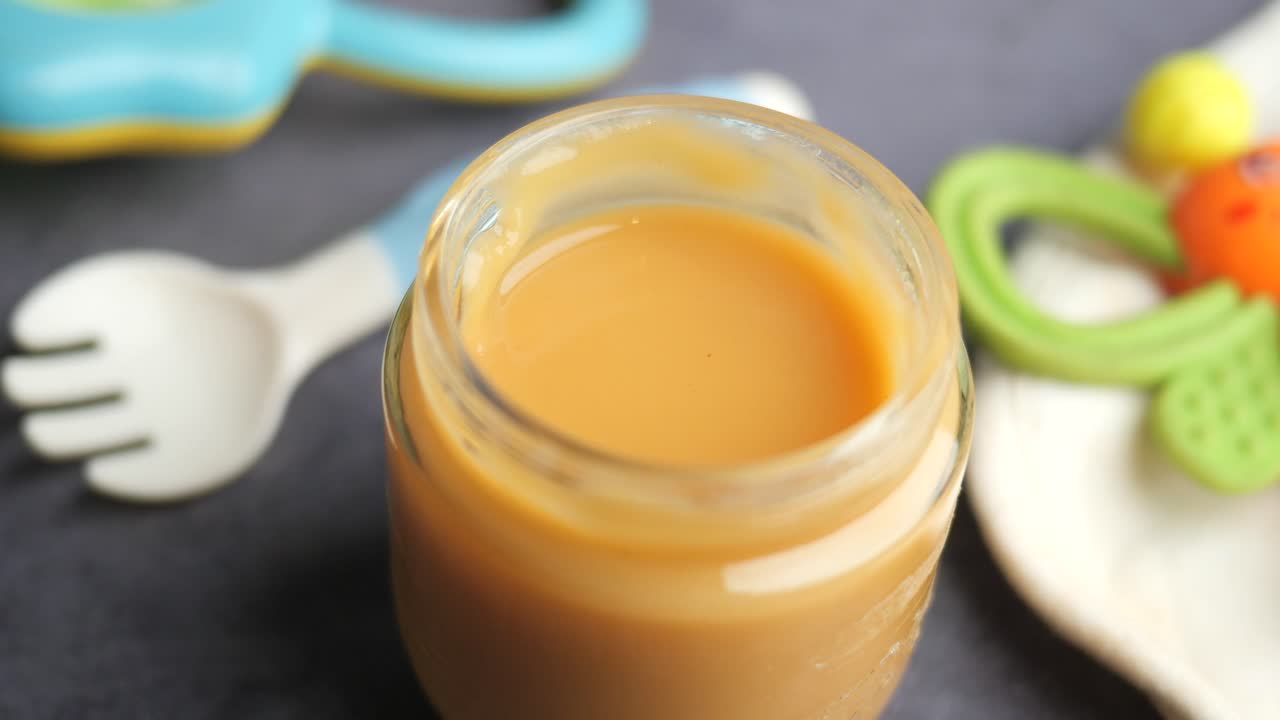 Baby Food in Glass Jar with Baby Accessories