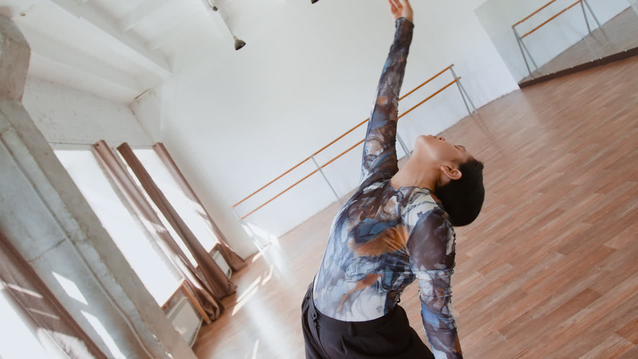 Dancer performing contemporary dance in a bright studio