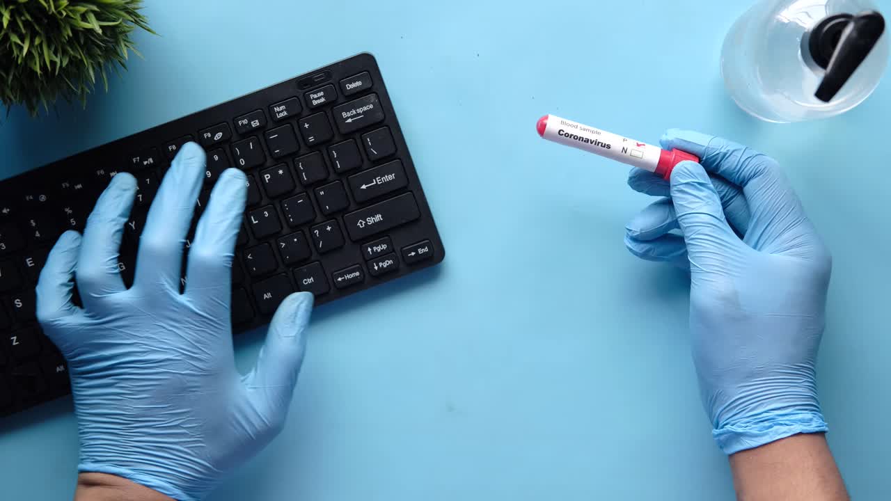 Coronavirus test and computer keyboard