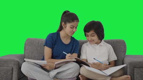 Happy-Indian-sister-helping-her-brother-in-studies-Green-screen