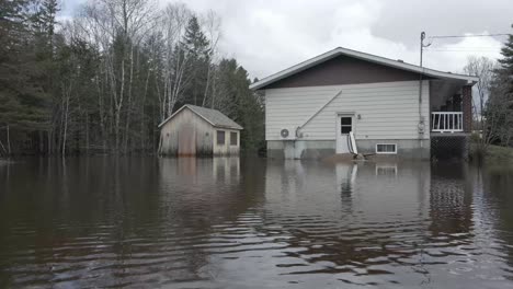aerial shot of flooded homes, trailers, and streets in quebec neighborhood.