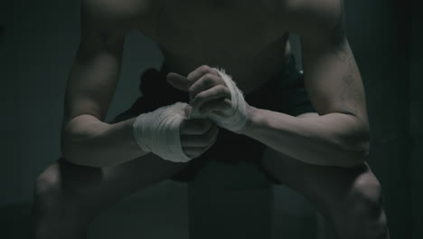 pale bald skinny man badnages his hands in the creepy old bathroom at night
