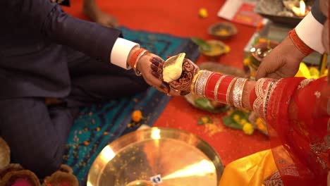 slow motion shot of a hindu couple with conch shell (sankh) in hand during traditional hindu wedding in india.