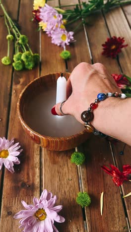 candle lighting ritual with flowers and crystals