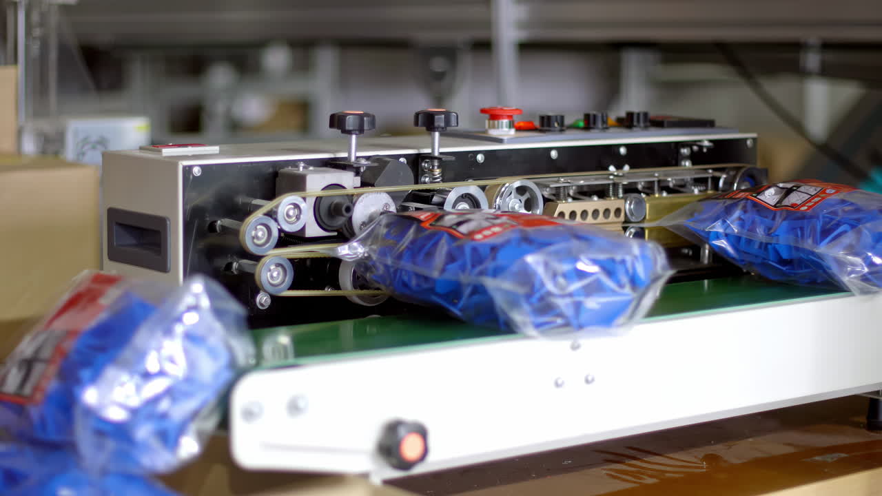 Sealing process as bags on conveyor belt get heat sealed by machine, fast motion