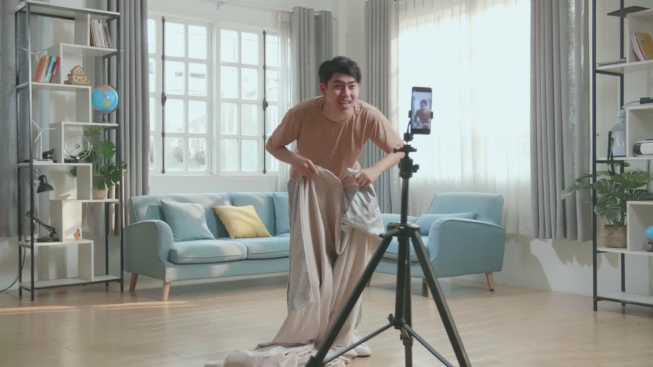 Man filming a funny video in his living room
