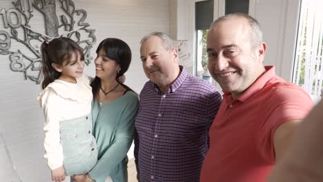happy non-normative family taking a selfie at home