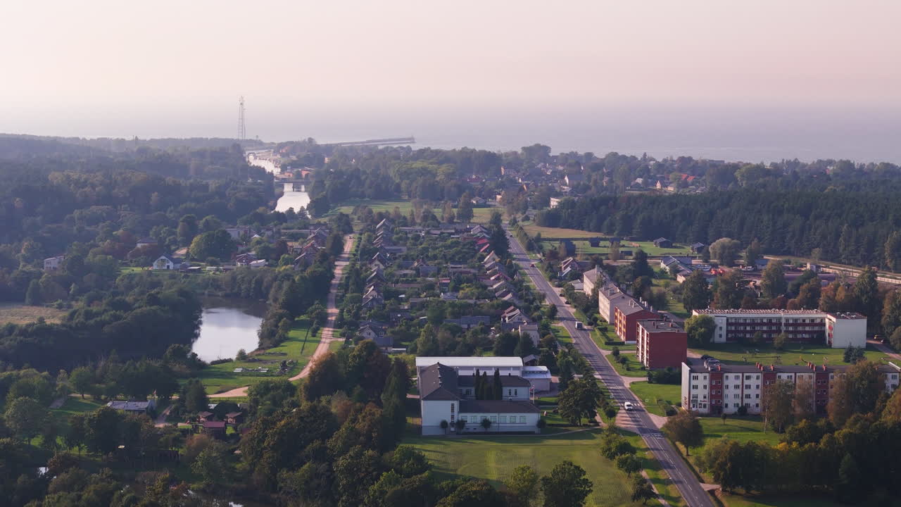 Aerial footage of Pavilosta Latvia showing town layout and river reaching the sea.