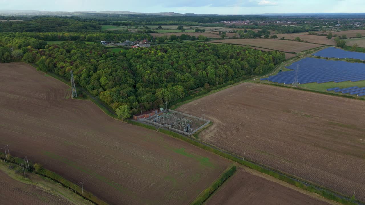 Aerial drone view of solar power plant in rural farm fields near Ratby, Leicester, UK, showing photovoltaic panels and countryside
