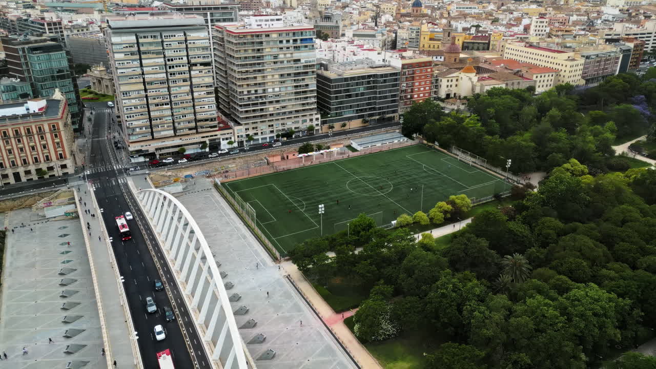 Cars and public transportation moving on the Exhibition Bridge near the Mestalla Stadium, and the Turia Gardens Park in Valencia, Spain