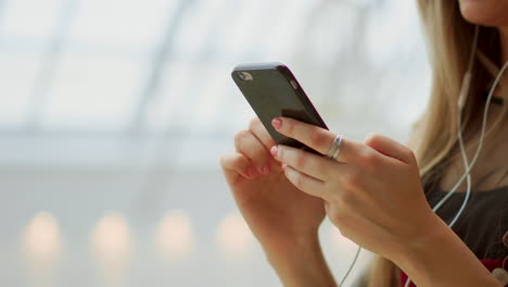 happy teenage girl holding bags with purchases, smiling while looking at phone in shopping center. received good news, reading message, texting. horizontal photo banner for website header design