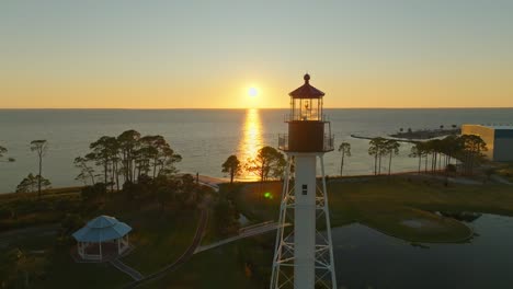 drone strafe of an orange sunset and beautiful coastal views at cape san blas lighthouse in port st