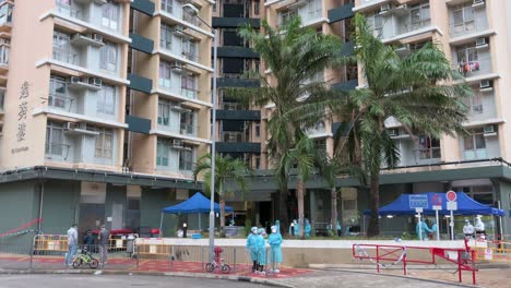 health workers are seen outside a public housing building placed under lockdown after a large number of residents tested positive