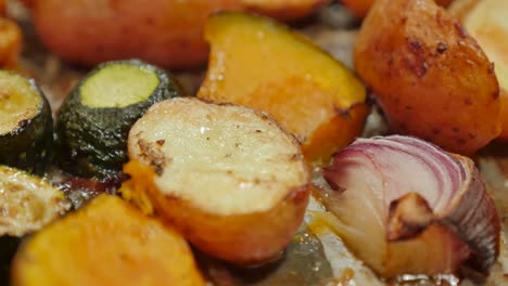 picking up roasted vegetables on a tray