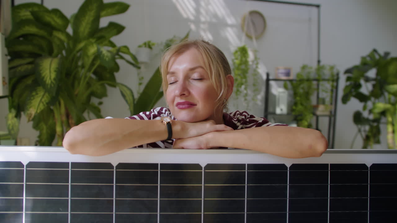 Young Alternative Energy Specialist leaning on Solar Panel