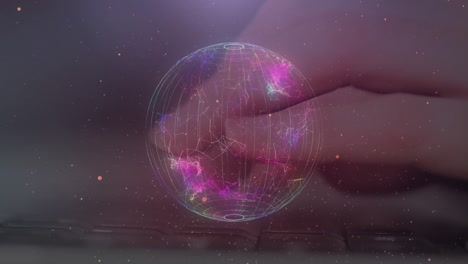 Animation of globe of network of connections over person typing on computer keyboard