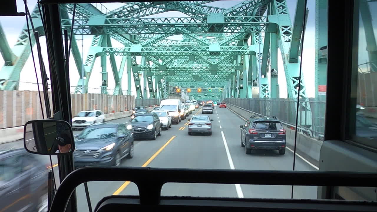Front View Through Windshield Inside Bus Driving On Bridge With Cars Traffic and Lanes