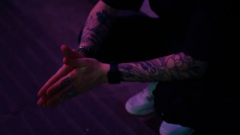 tattooed person's hands and arms