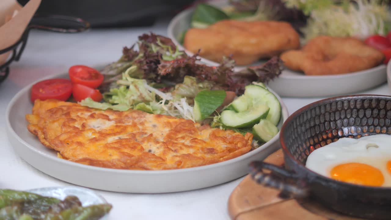 Delicious omelet with salad and sides