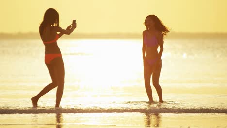 multi ethnic girlfriends in swimwear on ocean beach