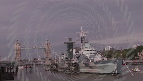 docked battleship on river with tower bridge and animation overlay pattern
