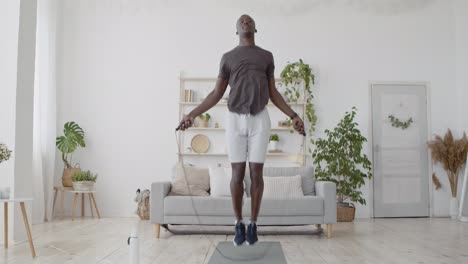 man jumping rope at home
